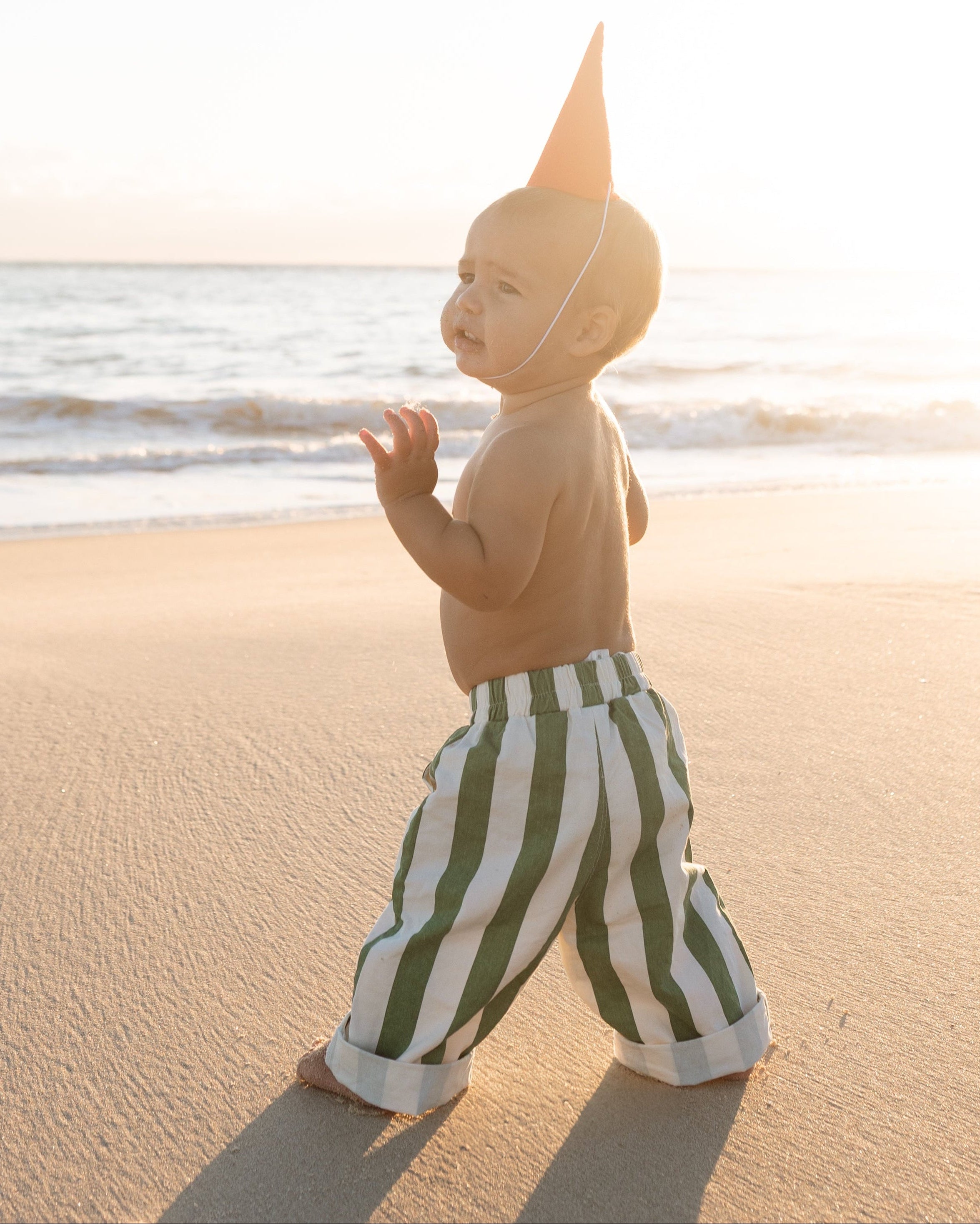 infant beach wear baby and toddler boys green and white striped pants walking on the beach