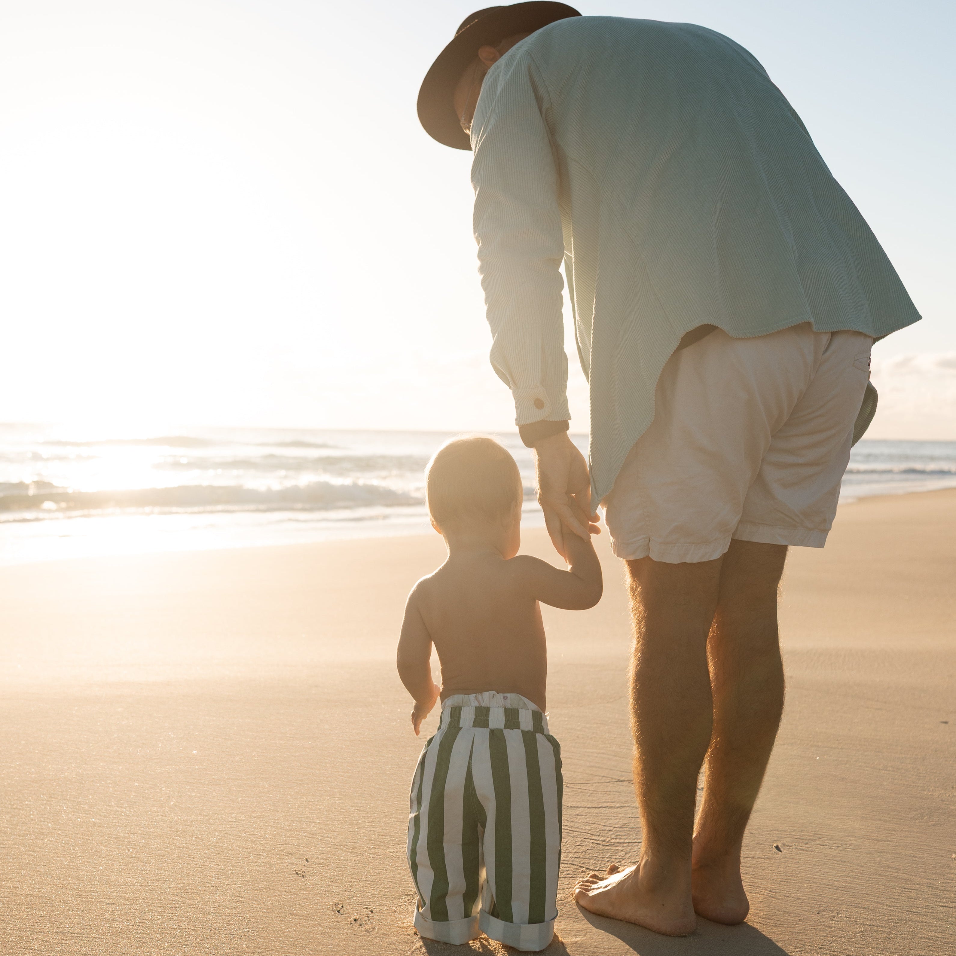 infant beach wear baby and toddler boys green and white striped pants baby boy on beach with his dad