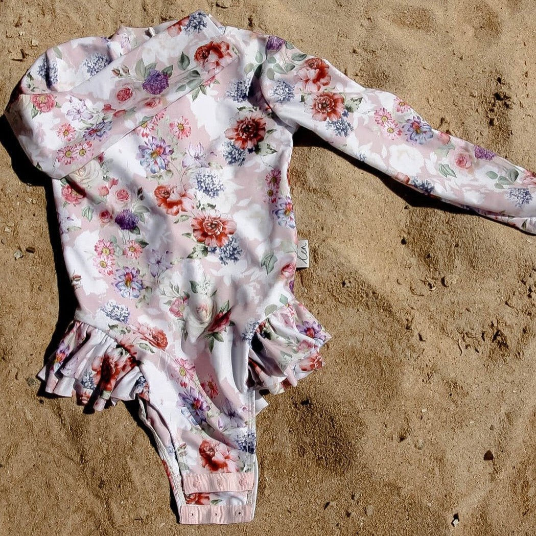 Swimsuit for babies, toddlers and girls with nappy change snaps for toilet training, dressing and nappy changes.