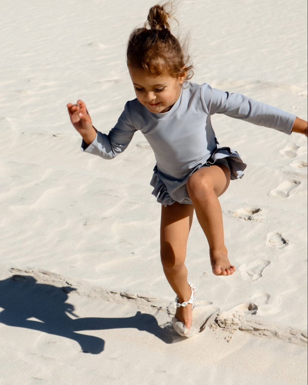 toddler in infant swimsuit with nappy change snaps