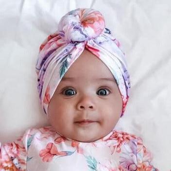 baby girl wearing a swim turban and matching swimsuit with nappy change snaps