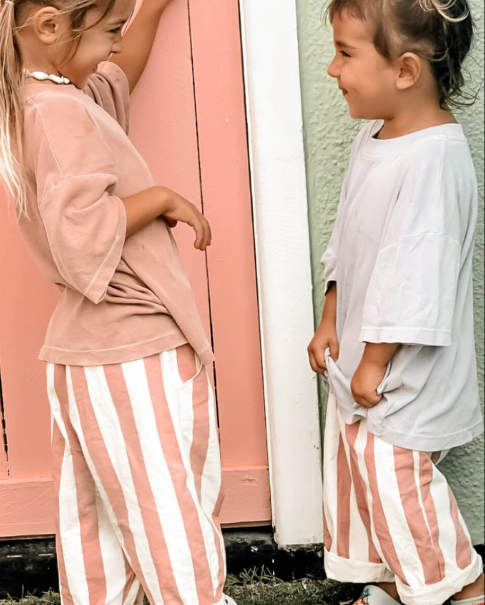 pink and white stripe sisters wearing toddler girls beachwear pants and a shell anklet