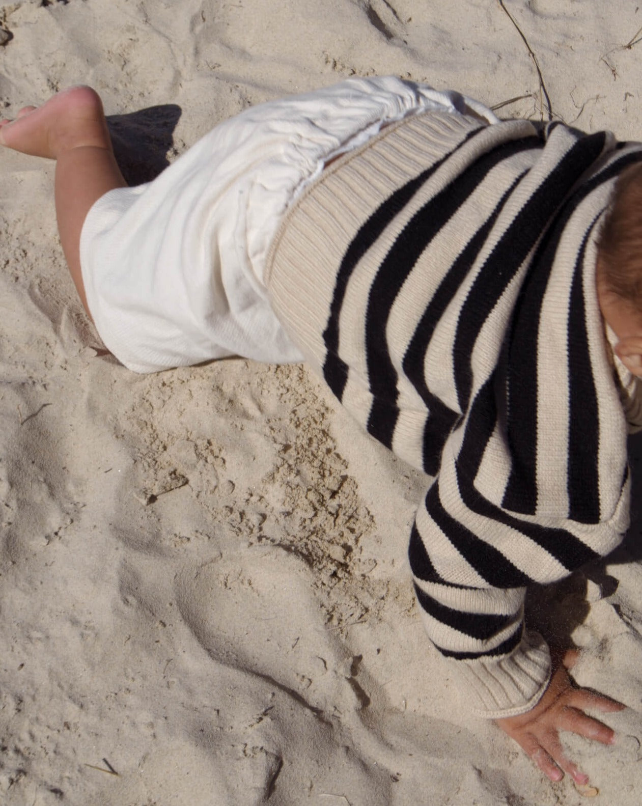 infant wearing a warm oversized stripe surf knit