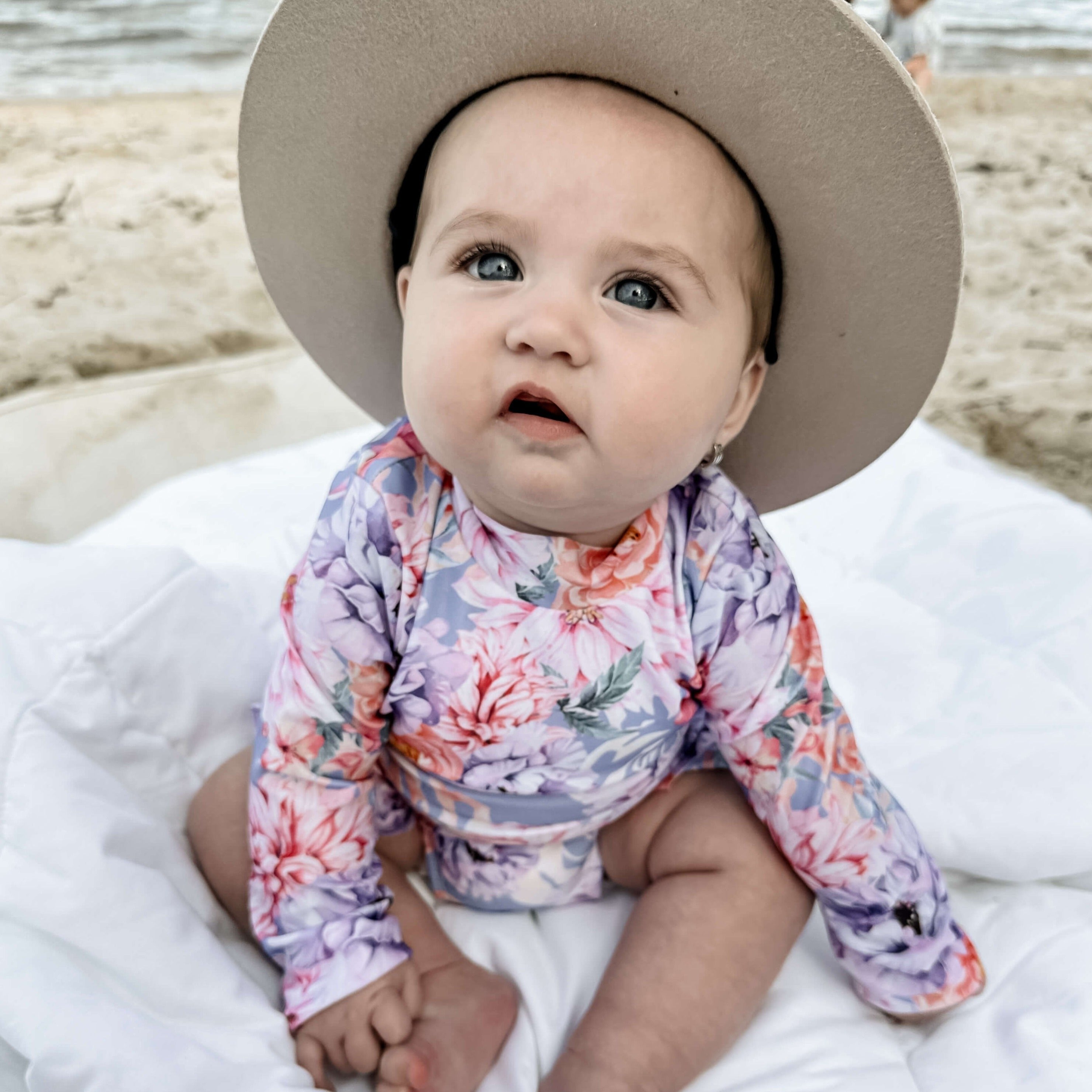 Baby wearing a premium swimsuit with nappy change snaps that is sensory friendly