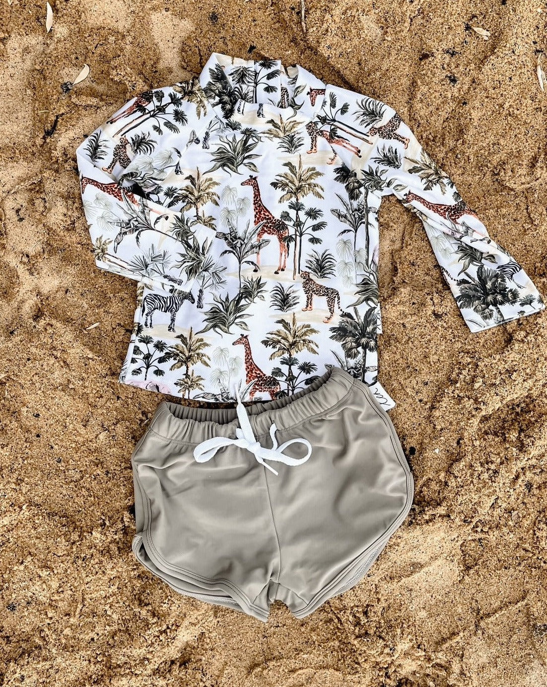 Baby and childs swimsuit with girrafes, zebras, tigers and elephants on it.