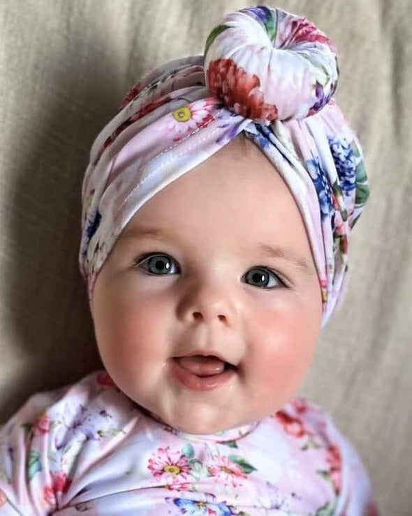 Baby wearing a matching swim turban and swimsuit long sleeve sun safe