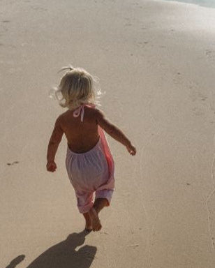 pink baby girls beach cover up at the beach.