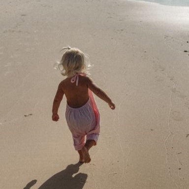 pink baby girls beach cover up at the beach.