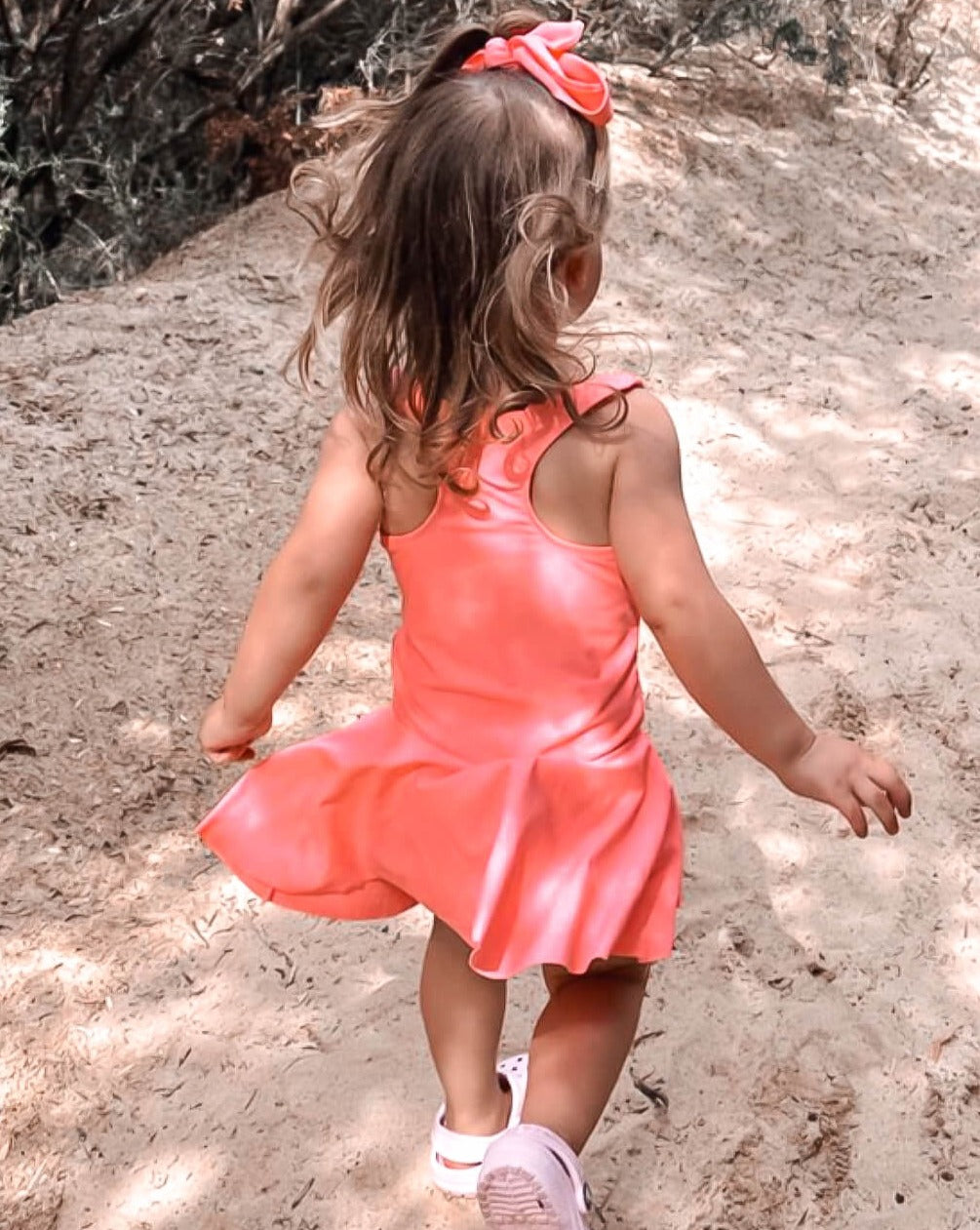 Young girl in a swim dress with nappy change snaps