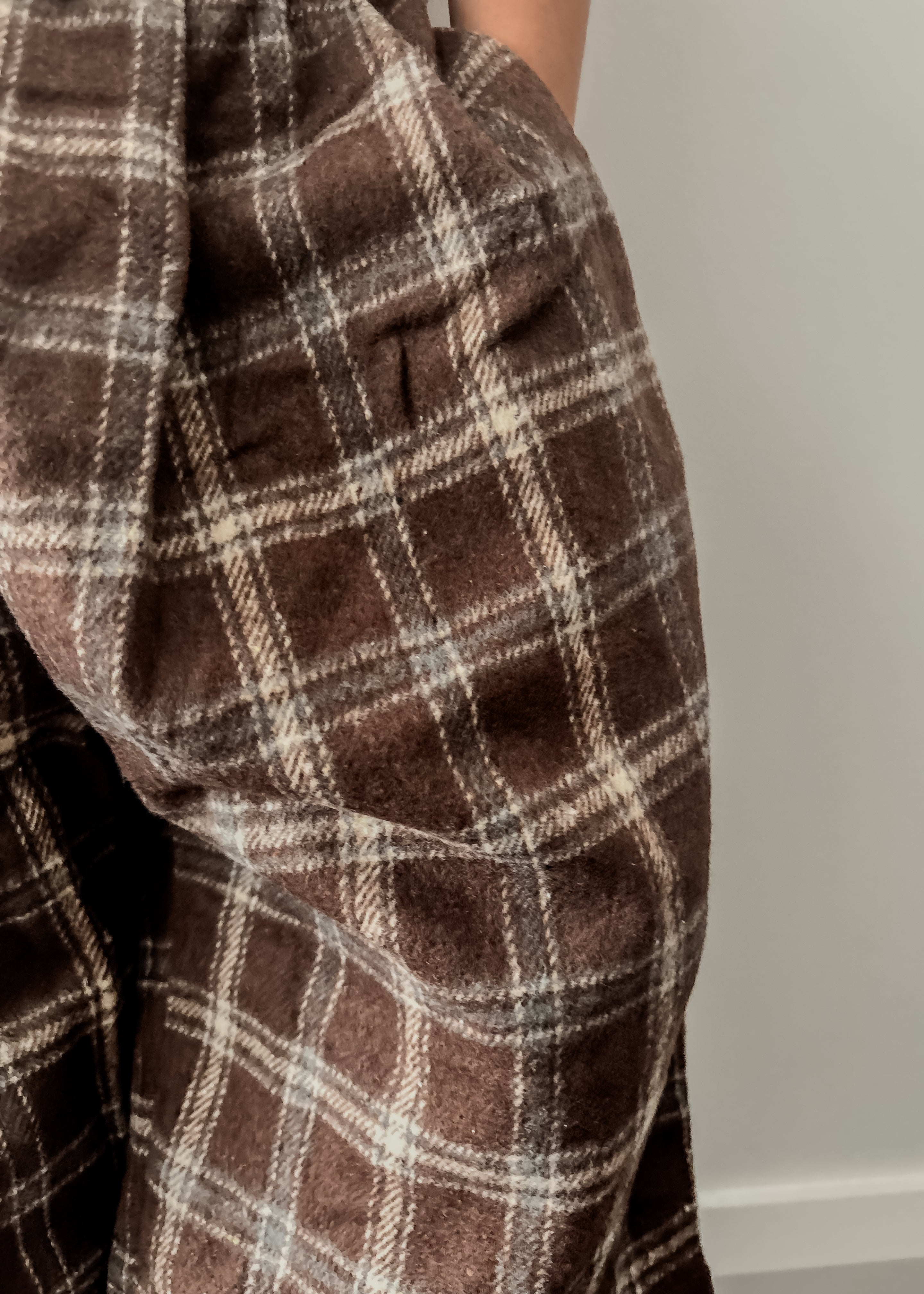 Brown plaid pants with a neutral background