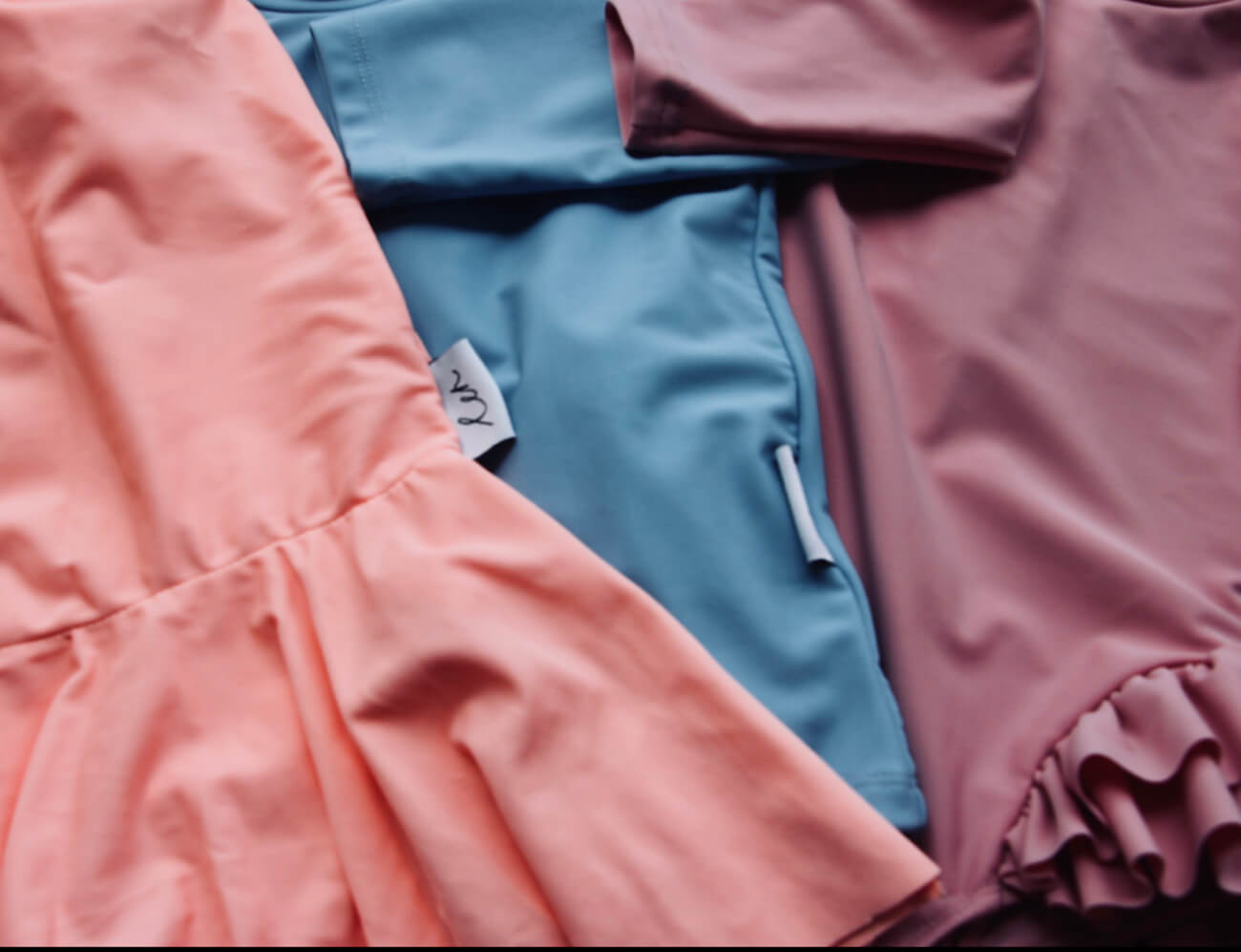 Kids Ballerina Swimwear in various muted colours laid flat