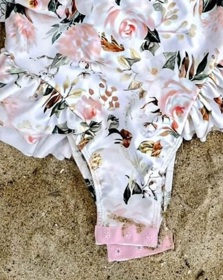 girls swimsuit on the sand that has nappy change snaps
