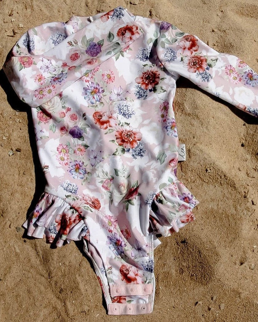 Swimsuit for babies, toddlers and girls with nappy change snaps for toilet training, dressing and nappy changes.