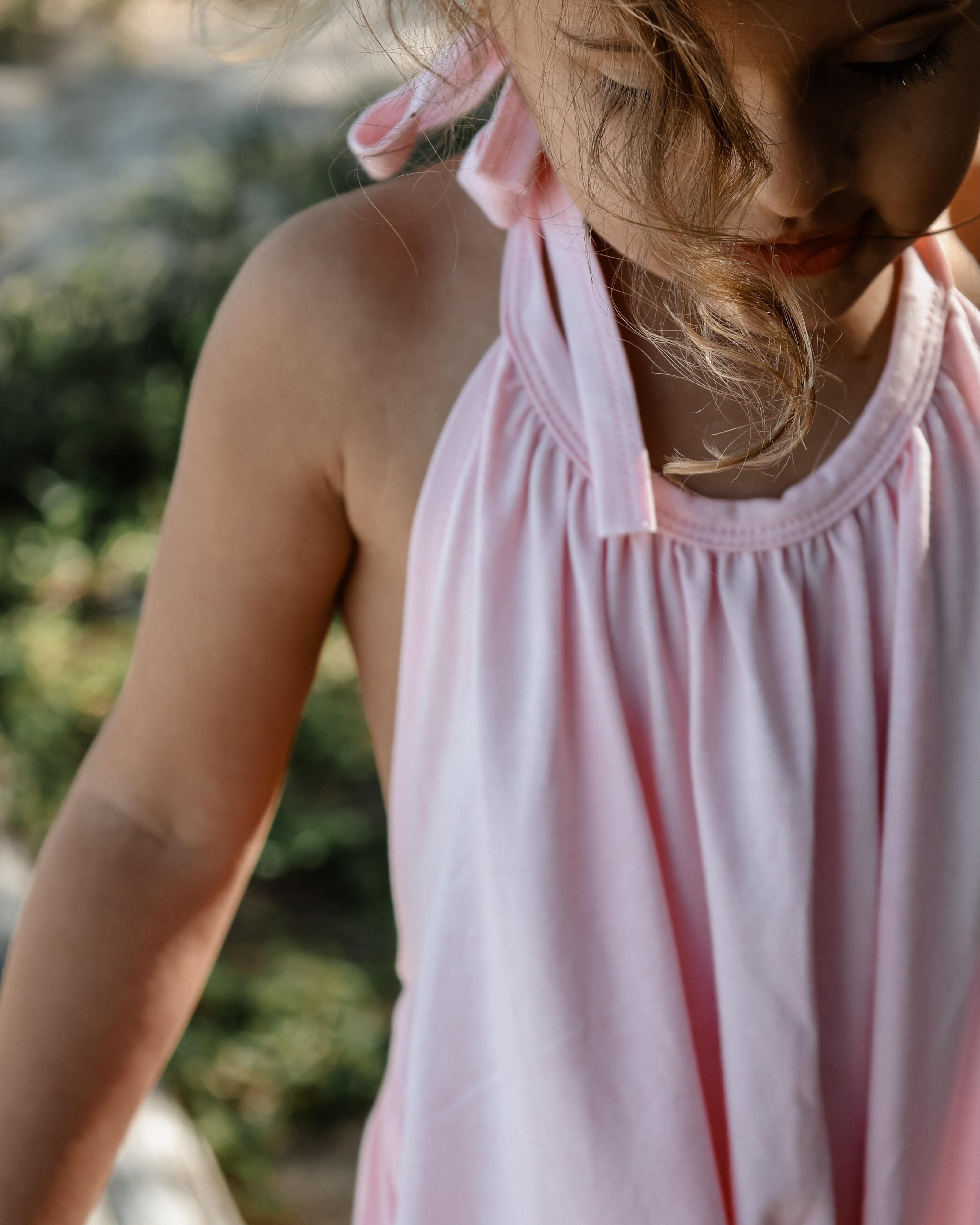 girl in pink beach wear halter summer onesie