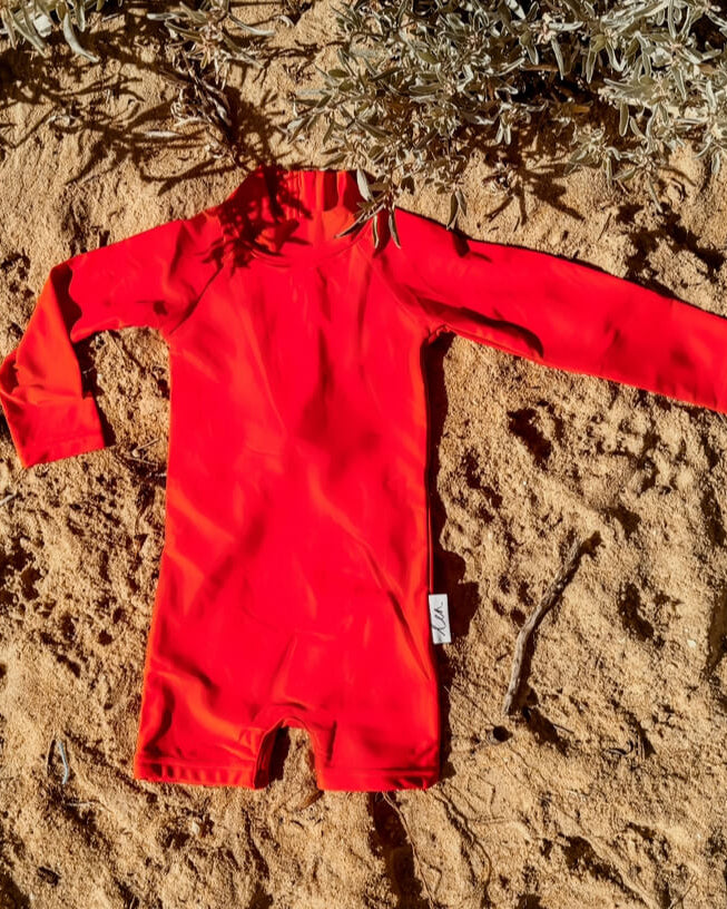 one piece toddler boy swimsuit one piece with snaps. bright neon red upf50