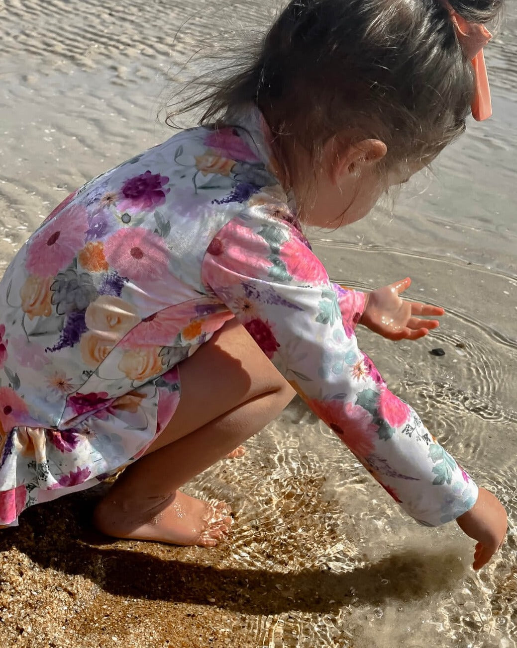 Baby Girls Long Sleeve Swimsuit With Nappy Change Snaps at the beach