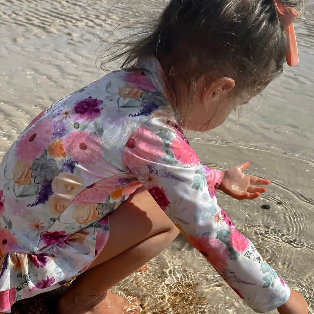 Baby Girls Long Sleeve Swimsuit With Nappy Change Snaps at the beach