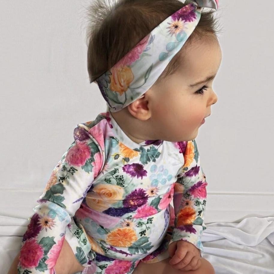 Baby Girls Long Sleeve Swimsuit With Nappy Change Snaps In The Color Posey