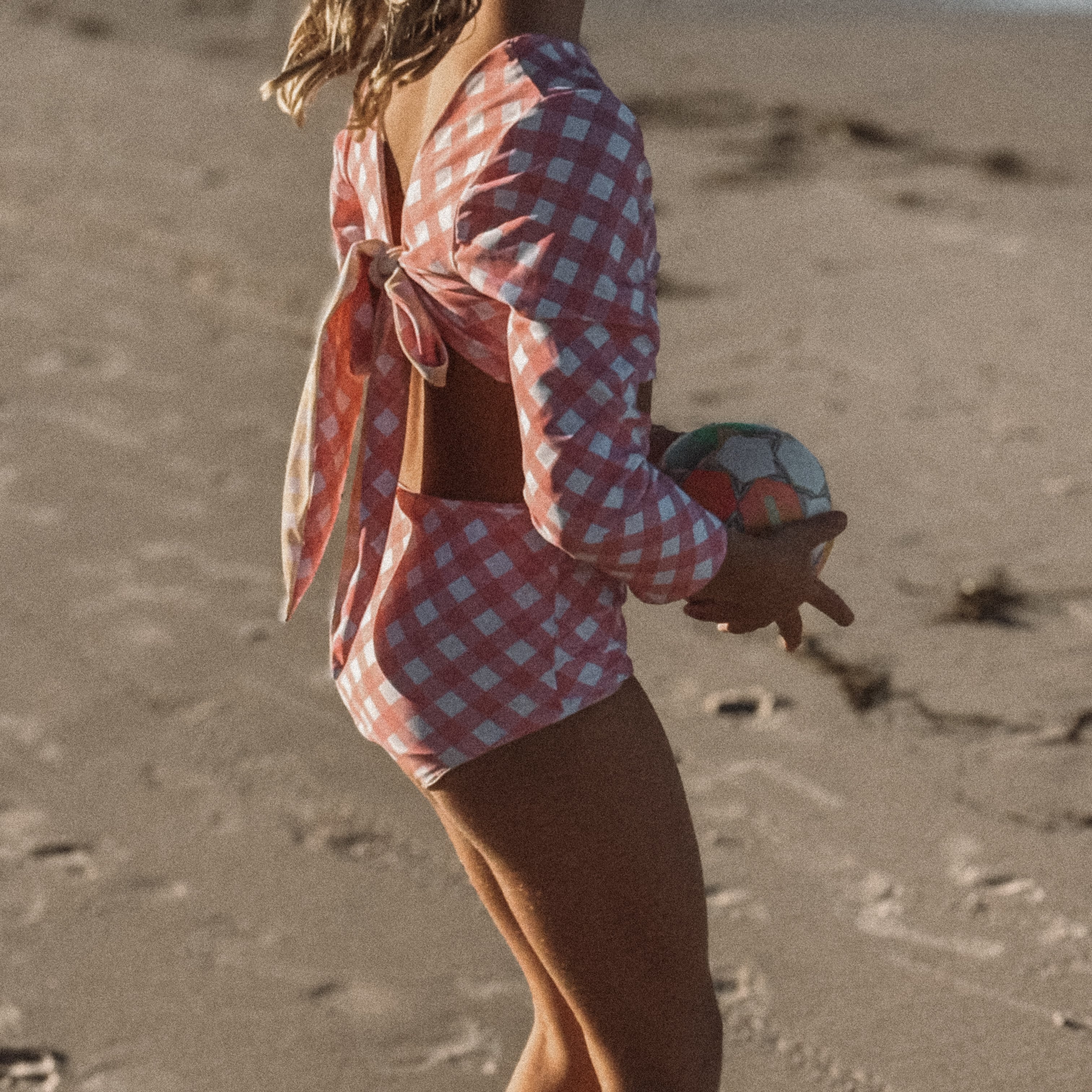 girls reversible  two piece swimsuit playing ball on the beach