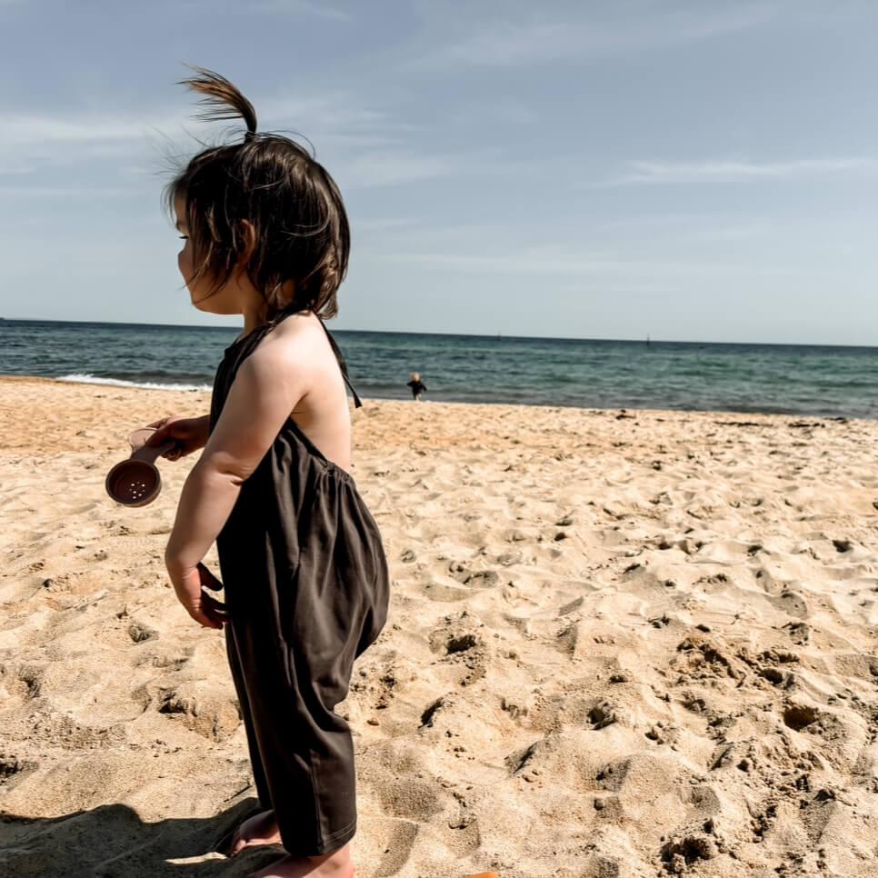 toddler girl in a halter oneise sun suit