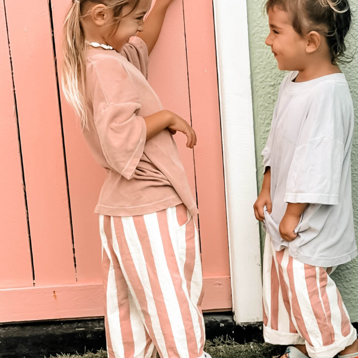  pink and white stripe sisters wearing toddler girls beachwear pants and a shell anklet