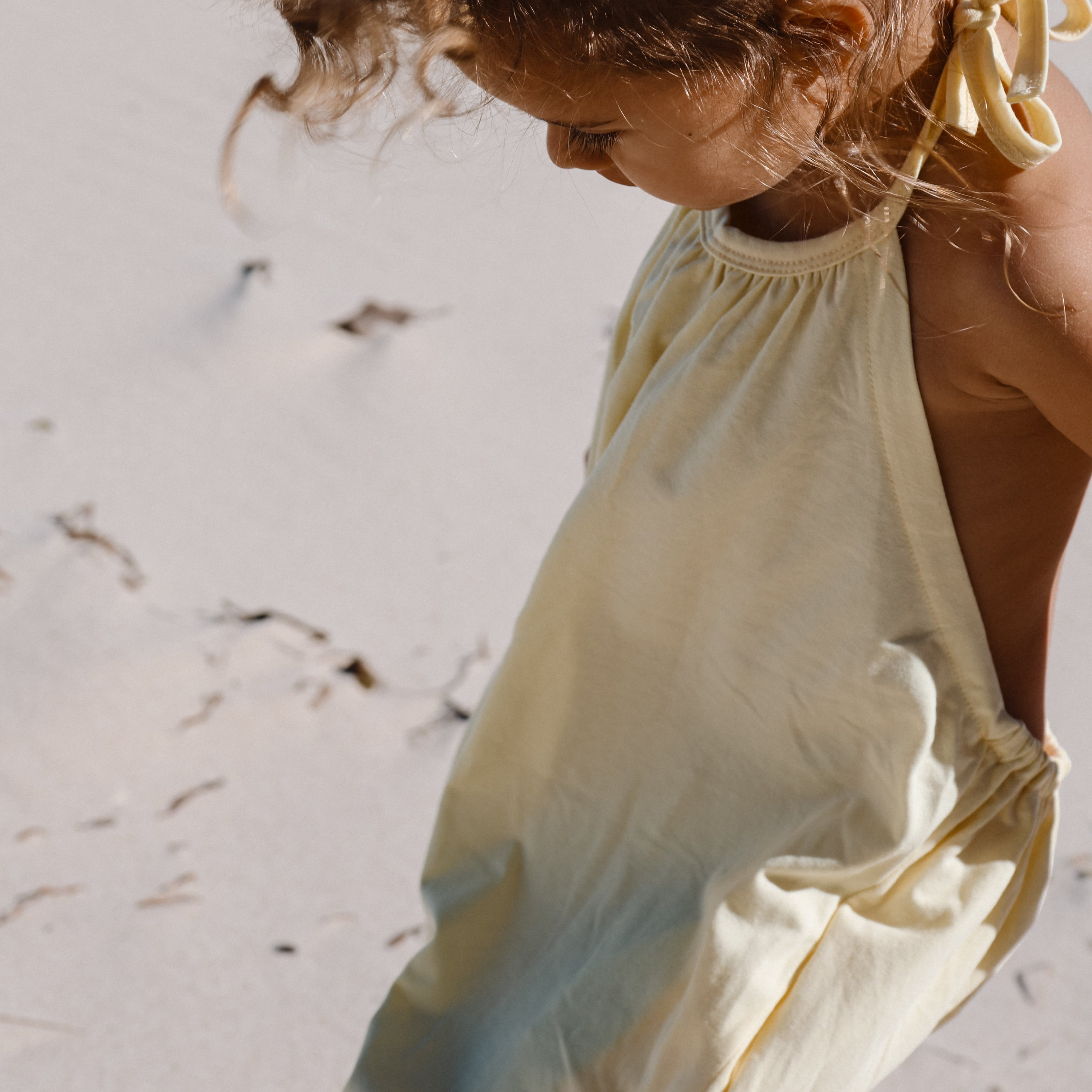girl in yellow beach wear halter summer onesie