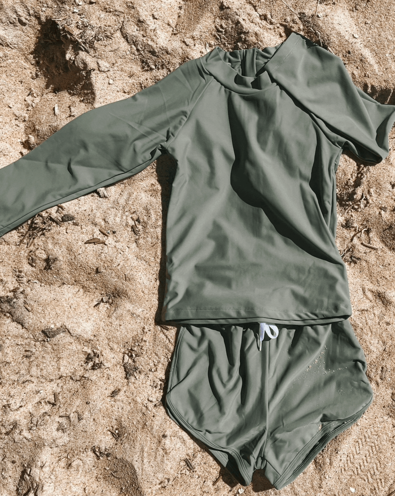 Olive rash set for girls and boys and babies laying flat on the sand