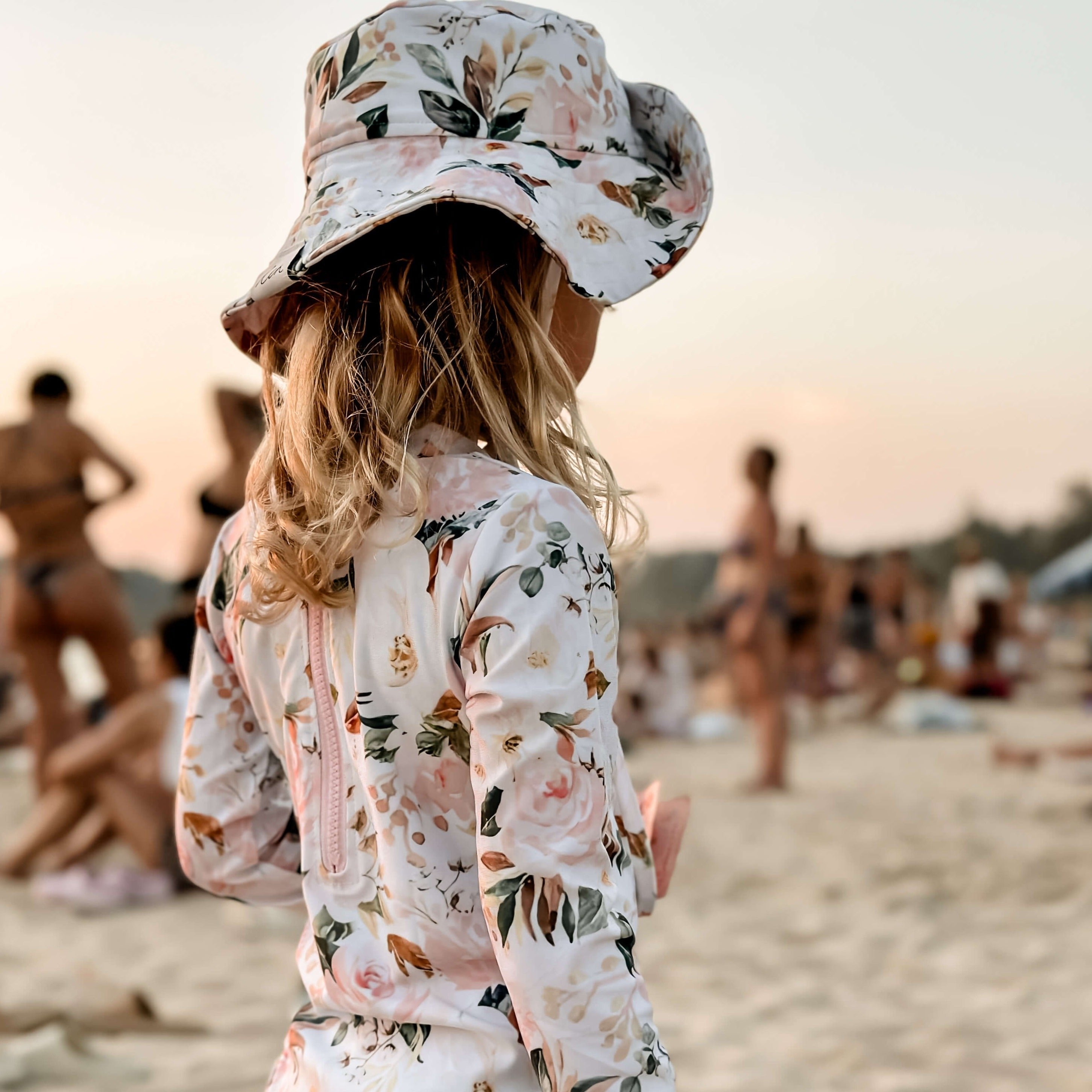 girl in a swimsuit with long sleeve and change snaps with a matching swim hat