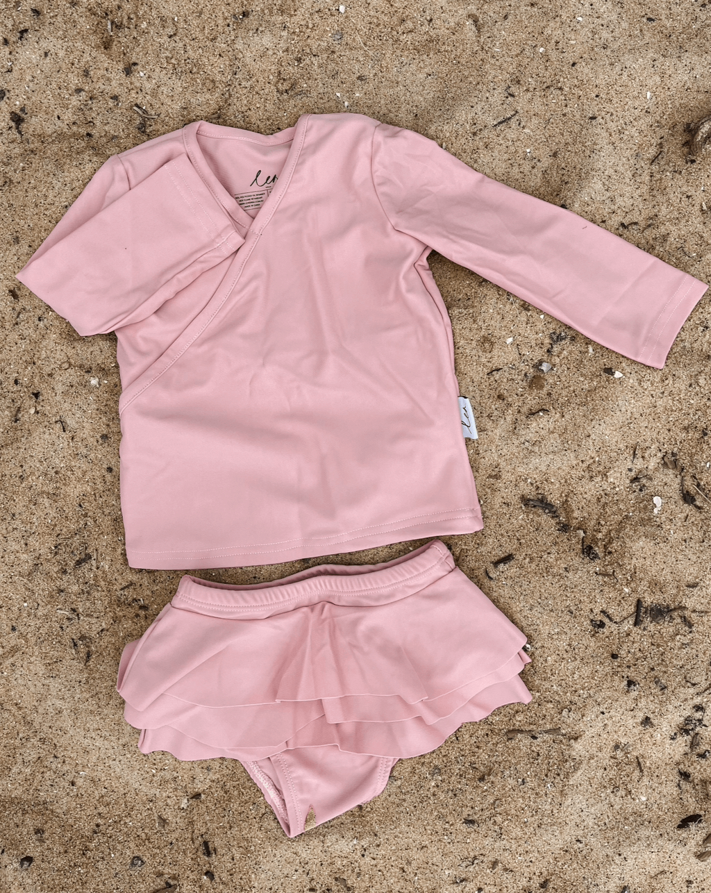 A flat lay of ballerina rash top and rara shorts bloomers swimwear rash set