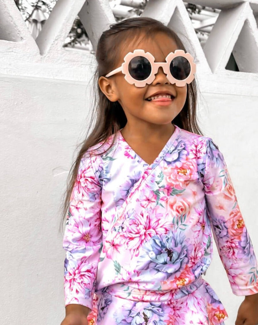 cute toddler wearing matching floral swim set in premium fabric