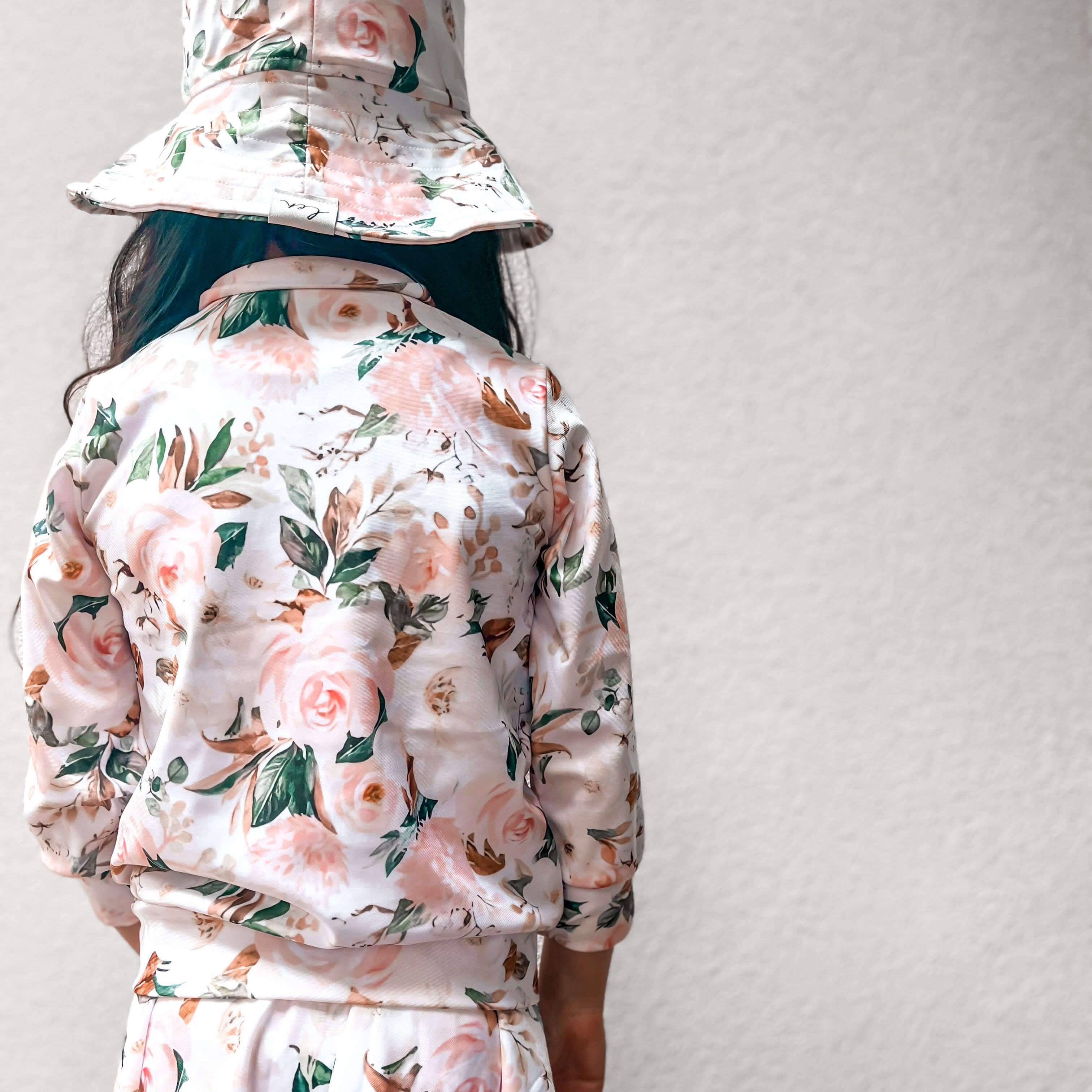 The back of the len swim jacket, swim dress with snaps, and swim hat.